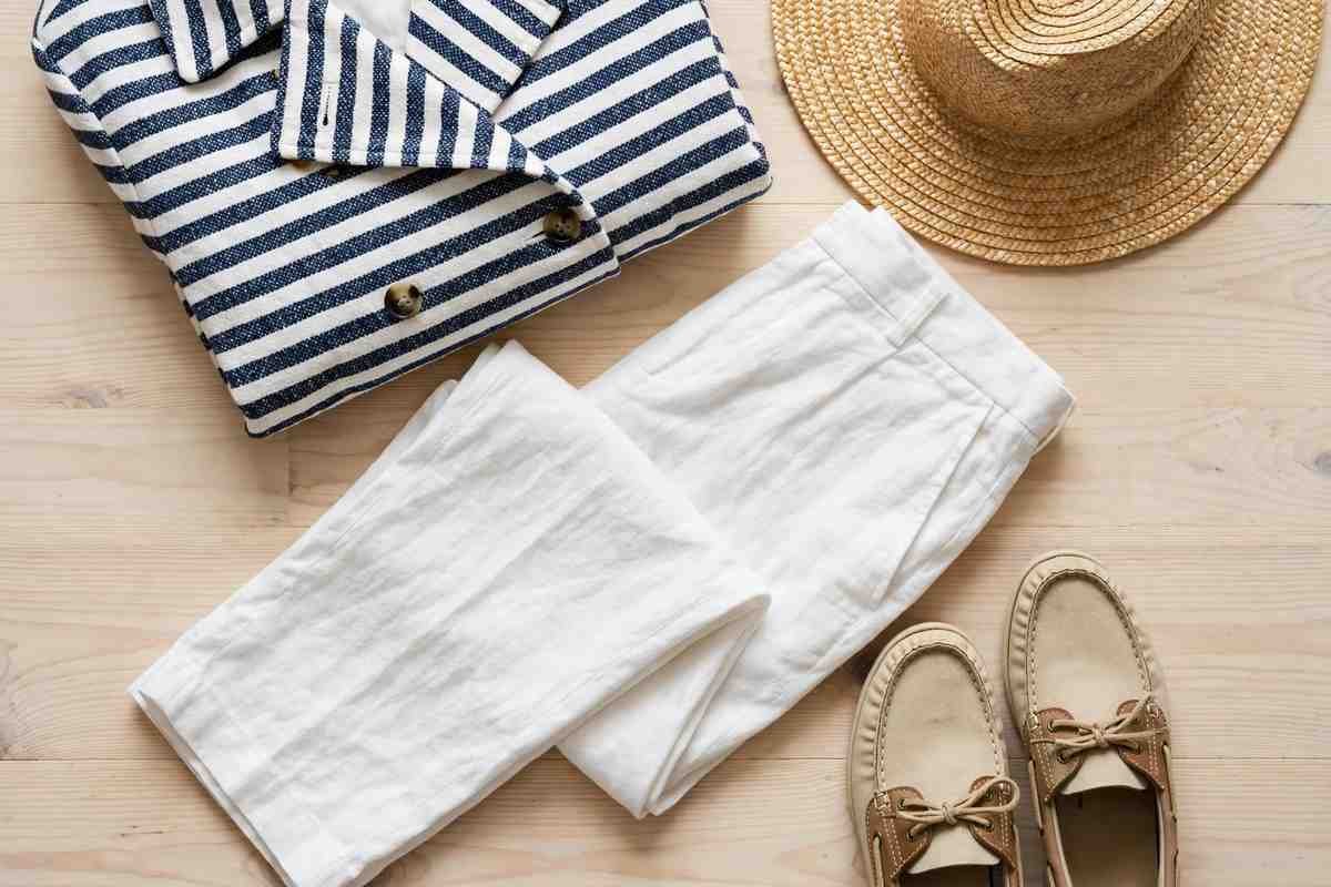Nautical wardrobe flat lay with striped jacket and boat shoes